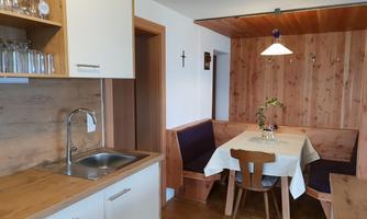 A cozy kitchen with a dining area. The room features warm wooden decor and an inviting atmosphere.