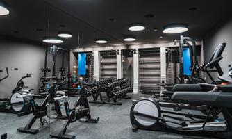 A modern gym with various training equipment. The rooms are well-lit and offer a pleasant atmosphere for workout.