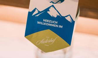 A water bottle with a label that contains a warm greeting. The image conveys an inviting atmosphere in a hotel.