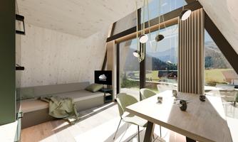 A modern, bright living room with a cozy sofa and a dining area. Large windows offer a view of the mountains and bring plenty of daylight into the room.