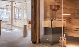 A bright and modern sauna with wooden interiors. The room feels welcoming and relaxing with large windows.
