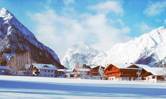 A wintry landscape with snow-covered mountains and traditional wooden houses. The sky is clear and the environment is quiet and idyllic.