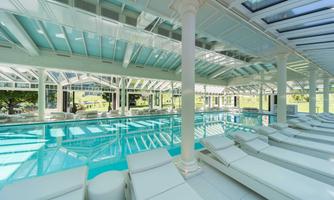 An elegant indoor pool with comfortable loungers and large windows that let in plenty of daylight. The luxurious space radiates serenity and relaxation.