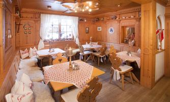 A cozy restaurant with wooden decor and traditional tables. The atmosphere is inviting and warm.