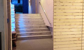 The entrance to the Kranzmühle at Lake Achensee. Bright stairs lead into the interior.