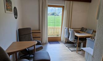 Living kitchen with dining table, 2 recliners, and television, west balcony