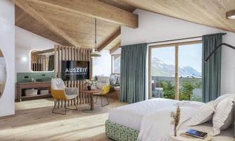 A modern hotel room with wooden ceilings and large windows. The furniture is stylish and offers a beautiful view of the mountains.