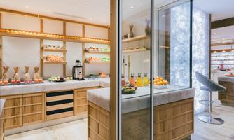 A modern kitchen with a vegetable and fruit buffet. Juicy fruits and colorful drinks are arranged on the counter and shelves.