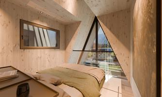 A modern bedroom with wooden walls and a large, triangular window. The bed is decorated with a blanket in soft shades.