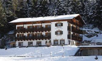 A beautiful house in winter, surrounded by snow-covered trees. The facade is traditional and invites relaxation.