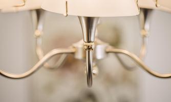 An elegant ceiling light with multiple lampshades. The design is modern and appealing.