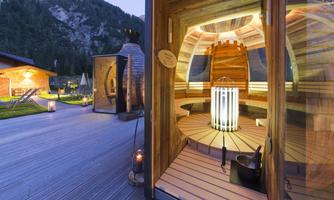 A modern sauna design in a relaxing environment. The wooden room is illuminated and provides a cozy atmosphere.