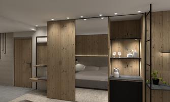 A modern bedroom with light wood decor and gentle lighting. The furnishings are designed to be minimalist and inviting.