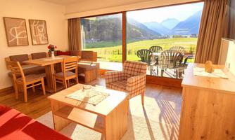 A bright and cozy apartment with a view of the mountains. The room is modernly furnished and has a dining area as well as a terrace.