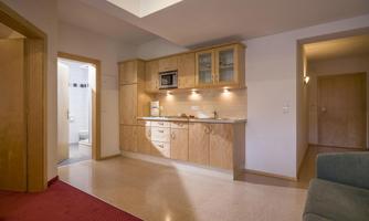 A modern kitchen with wooden cabinets and high-quality appliances. The space has a bright and inviting feel.