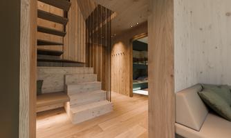 A modern designed interior with wooden stairs and soft lighting. The walls are made of light wood, creating a cozy atmosphere.