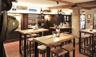 A cozy restaurant with wooden tables and chairs. The walls are decorated with shelves and decorations.