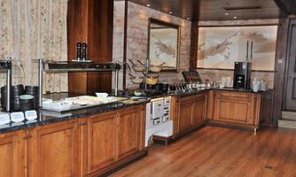A stylish buffet with wooden cabinets and a variety of dishes. The room is bright and invitingly designed.