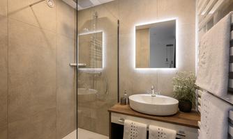 A modern bathroom with a glass shower cabin and a stylish sink. The design is simple and elegant, with warm wooden tones and stylish lighting.