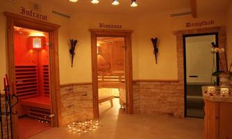 A relaxing wellness area with three doors to different saunas and a steam room. Soft light and decorative candles create a calming atmosphere.