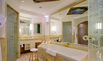An elegant bathroom with a large bathtub and stylish mirrors. It is bright and modernly furnished.