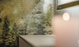 A gentle background with a patterned wall and soft lighting. A burning candle creates a calm atmosphere.