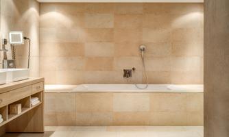 A modern bathroom with a bathtub and a shower. The walls are painted in neutral earth tones, creating a relaxing atmosphere.