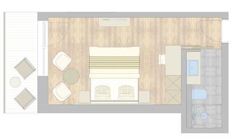 A modern room layout with a double bed, two armchairs, and a table. On the left side, there is a balcony with seating.