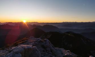 Sunrise over the mountains with a breathtaking panorama. The landscape is calm and in gentle colors.