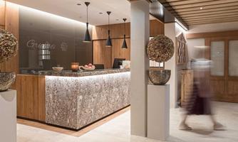 A modern reception area with wood and clean lines. A person moves through the space.