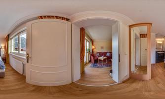 A cozy room with a double bed and a seating area. Large windows provide plenty of light and an inviting atmosphere.