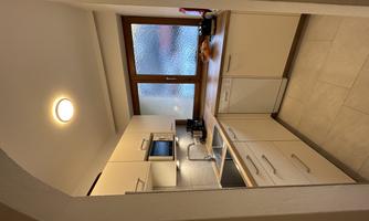 A bright and modern kitchen with a functional layout. The window provides natural light and a view outside.