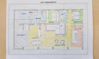 A colored floor plan sketch of a loft with various rooms. The areas are labeled, including living room, kitchen, and bedroom.