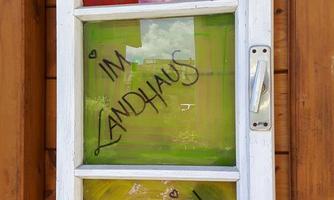 A colorful window with the inscription "Welcome to the Sonnenstein Country House." The vibrant design creates an inviting atmosphere.