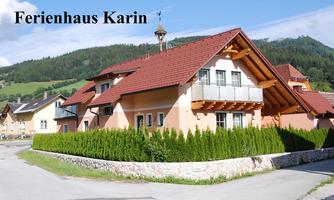 A charming vacation home with a red roof and green hedges. In the background, gentle hills are visible, creating a picturesque landscape.