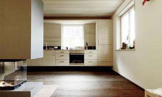 A modern kitchen with wooden floor and a large window. The space is bright and designed in a minimalist style.