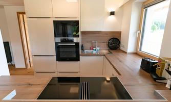 Modern kitchen with light wood and sleek appliances. The open design creates an inviting atmosphere.