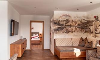 A modern room with wooden furniture and an artistic wall design. The cozy atmosphere invites you to relax.