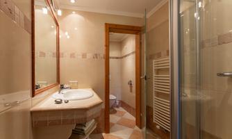 The Alina-Chiara apartment features two separate bathrooms, each equipped with a sink, shower, and toilet.