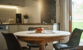 The dining table in the Linda apartment with a beautiful view out into nature.