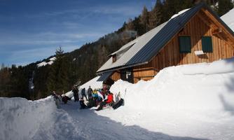 Enjoying the sunshine in winter in front of the cabin