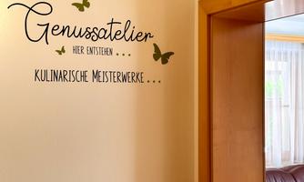 An inviting studio with the inscription "Pleasure Studio" on the wall. The decoration features butterflies and conveys a creative atmosphere.