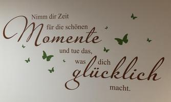 A wall design featuring the inspiring quote: "Take time for the beautiful moments and do what makes you happy." Green butterflies complement the design.