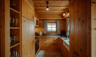 A cozy wooden kitchen with cabinets and a window. The atmosphere is warm and inviting.