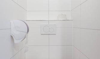 A modern and bright restroom with white tiles. The toilet is clean and minimally furnished.