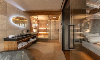 A modern bathroom with a glass shower cabin and wooden elements. Bright colors and elegant design create a relaxing atmosphere.