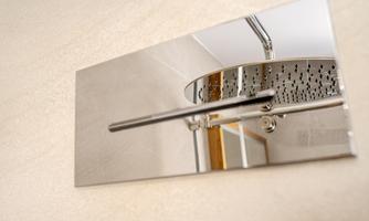 A modern shower head design made of shiny metal. The elegant surface fits well into a stylish bathroom.