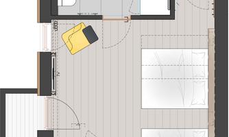 A room overview with two beds, a bathroom, and a living area. The modern design includes an armchair and a television.