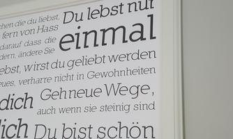A framed wall picture with motivational quotes in various fonts. The main message emphasizes that you only live once and that you are beautiful just the way you are.