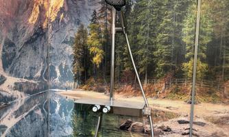 A modern barrier-free shower, with a thermostat glass shelf for utensils. A beautiful wallpaper with a picturesque mountain landscape, featuring a clear lake and forest.  <br/>It gives one the feeling of being in a pristine natural area while showering.
